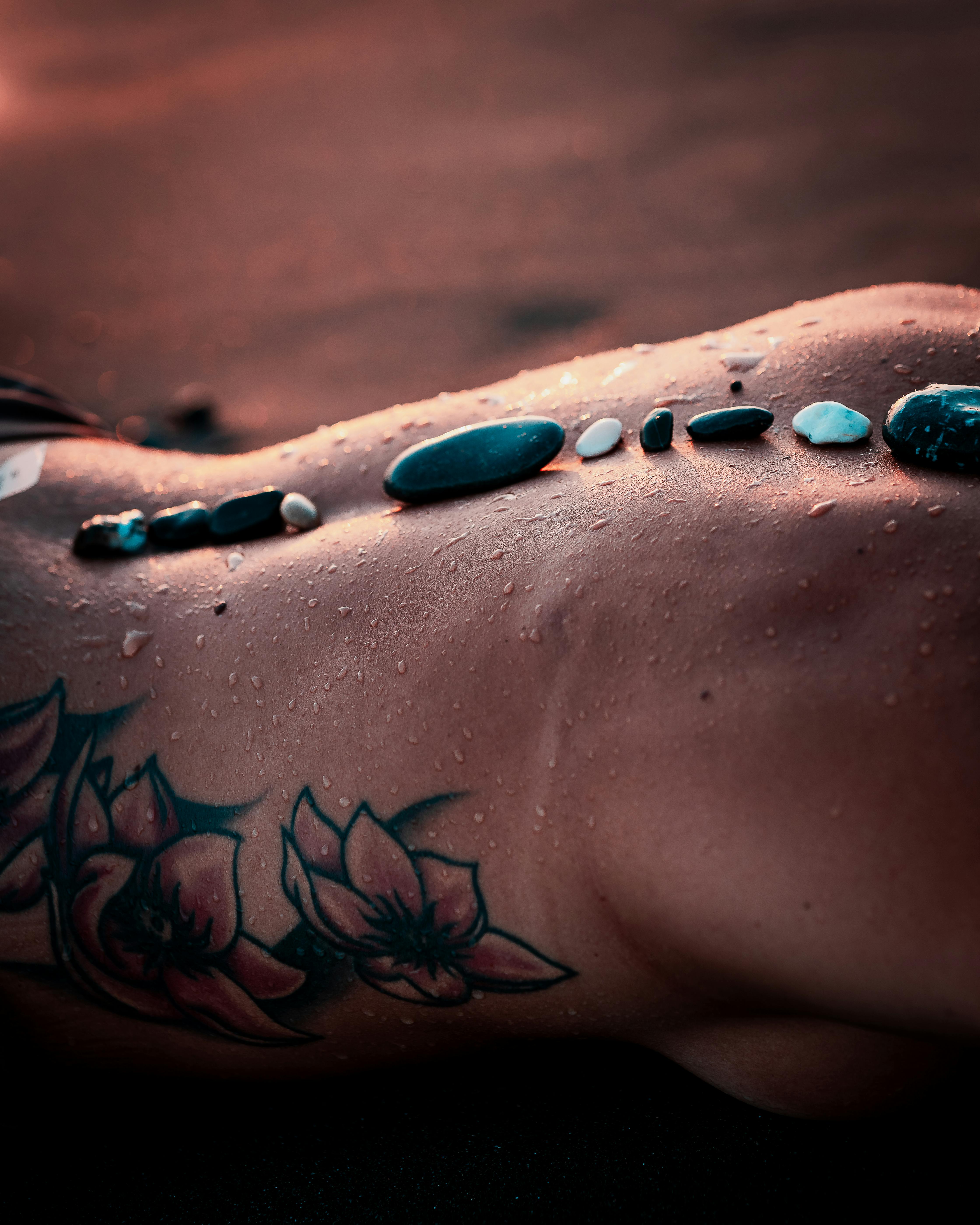 Micro-realistic water drop tattoo on the forearm