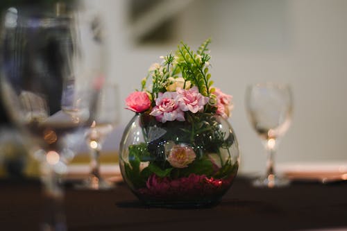 Close-up of a Flower Arrangement in a Glass Bowl on a Table 