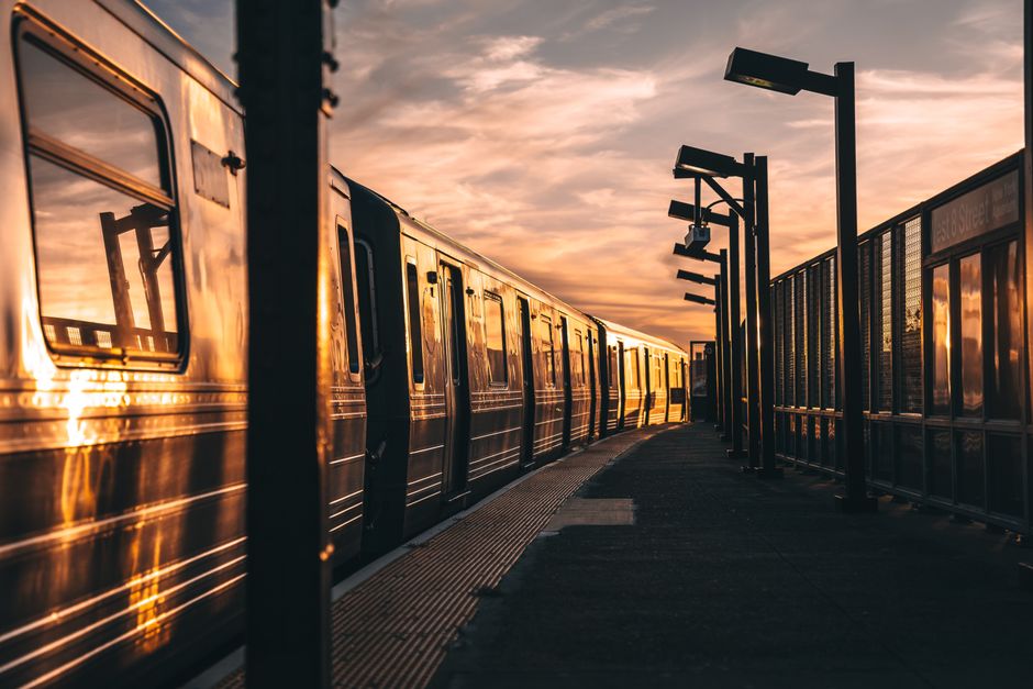 Gleaming train captured at sunset in Coney Island, New York, evoking a serene, urban travel mood.