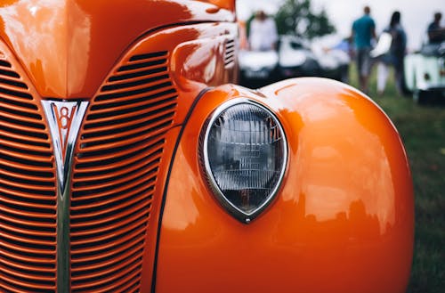 Selective Focus Photography of Classic Orange Vehicle