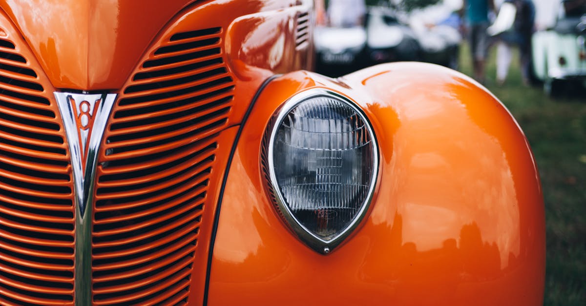 Selective Focus Photography of Classic Orange Vehicle