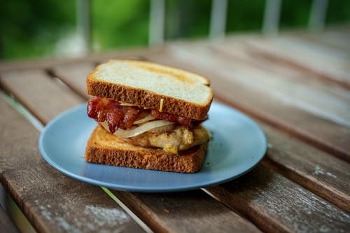 Sandwich Served on a Plate on a Wooden Table 