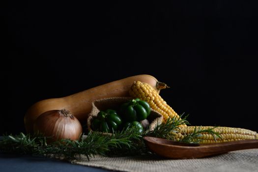 A beautifully arranged still life of fresh vegetables on a rustic wooden tray.