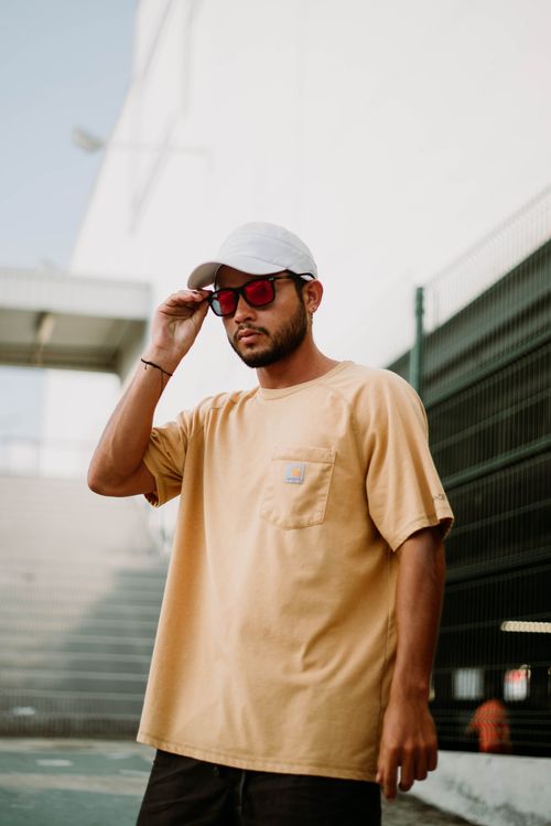 Free Stylish urban portrait of a man in a t-shirt with sunglasses. Stock Photo