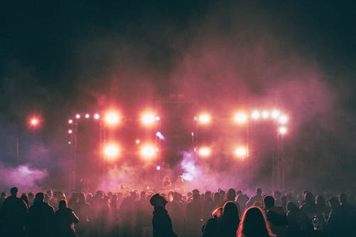 View of Audience and Illuminated Stage at a Concert during a Festival 