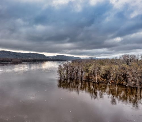 Free Dramatic overcast skies over a tranquil river in Weaver, Minnesota. Stock Photo
