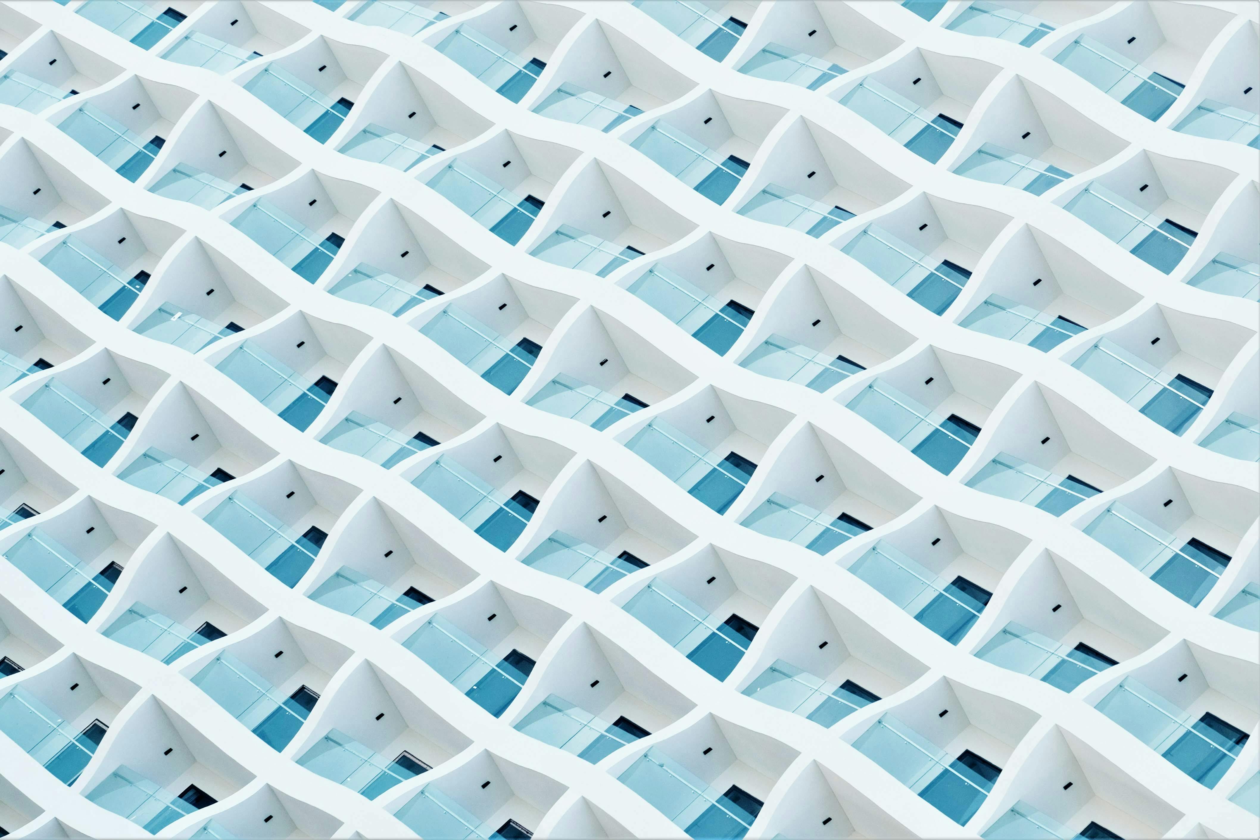 Abstract modern architecture with unique geometric patterns and blue windows.