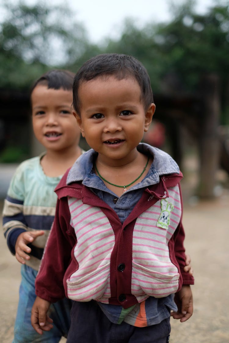 Two Little Boys Standing Outside 