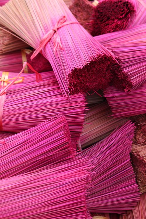 Free Bright pink incense sticks bundled together at a market in Hanoi, Vietnam. Stock Photo