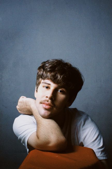 Casual portrait of a young man with mustache in a studio setting, Breves, Brazil.