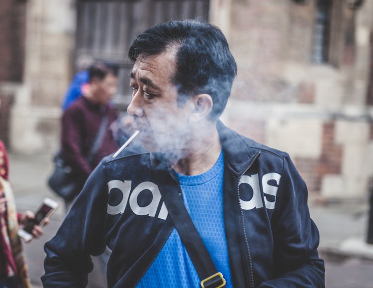 Man Smoking While Looking On Right Side