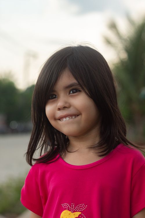 Free Cheerful young girl with black hair smiles warmly in Breves, Brazil. Stock Photo