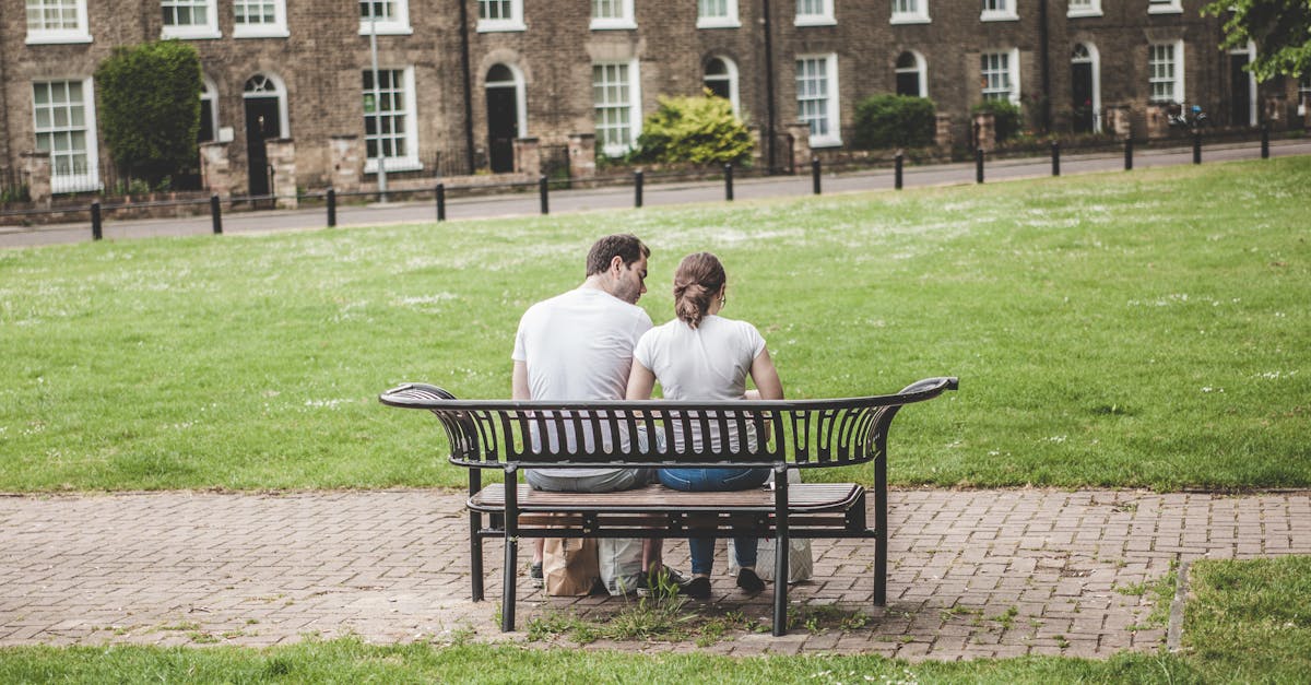 Man and Woman Sits on Black Steel Bench