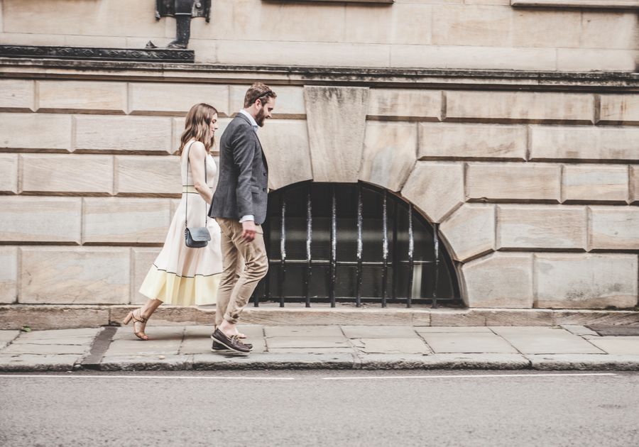 Elegant adult couple walking together through a city