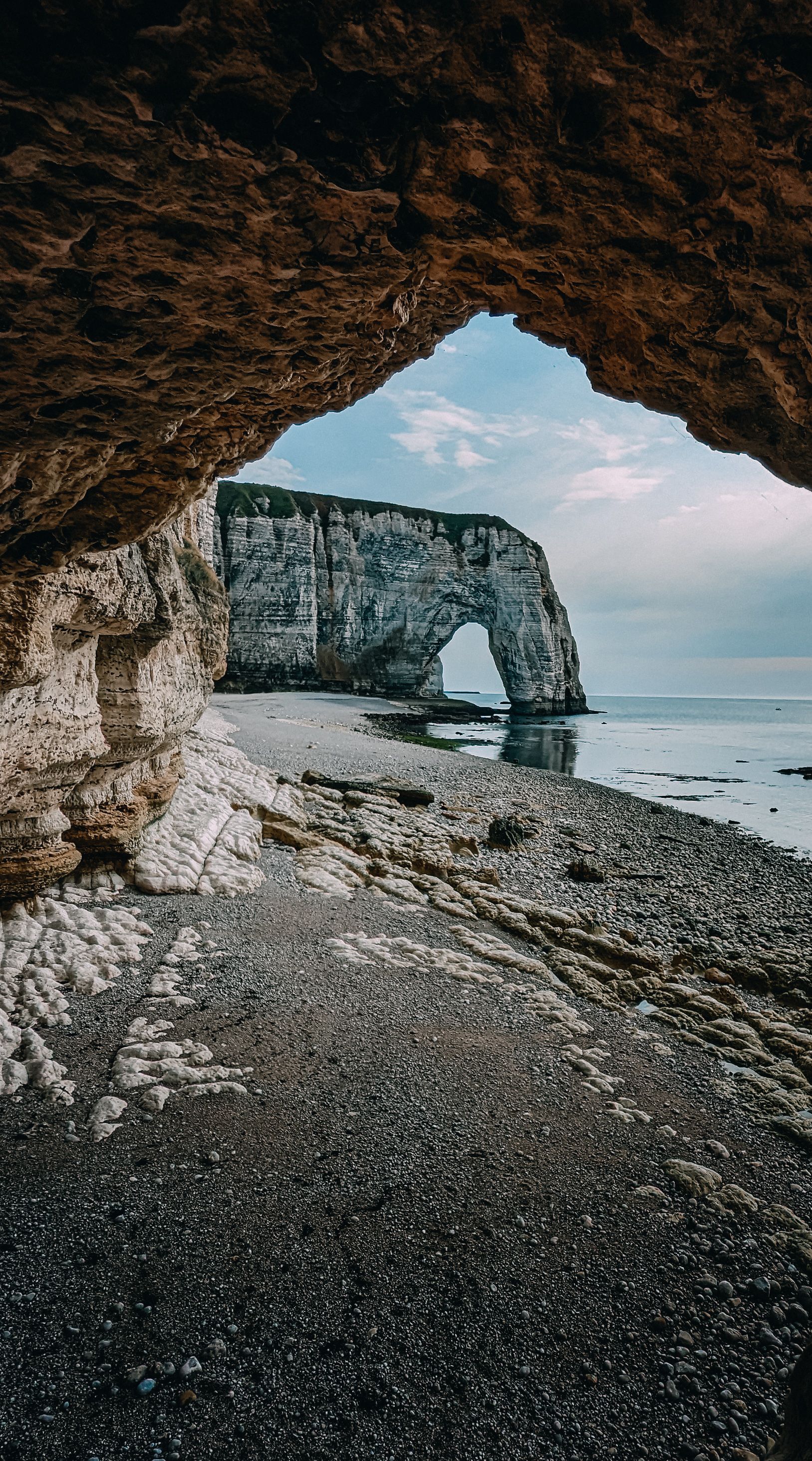 Woman in Bikini Sitting on Beach with Natural Arch behind · Free Stock ...