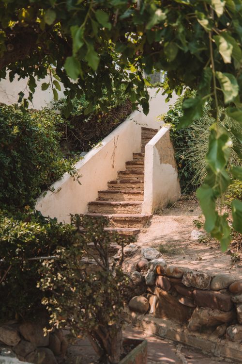 Free Stone staircase in a lush Valencia garden, surrounded by greenery and natural stone walls. Stock Photo
