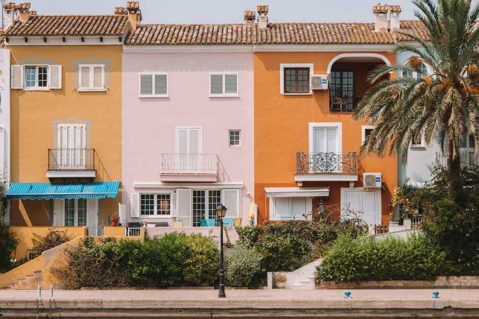 Vibrant Mediterranean-style houses with palm trees in Valencia, Spain.