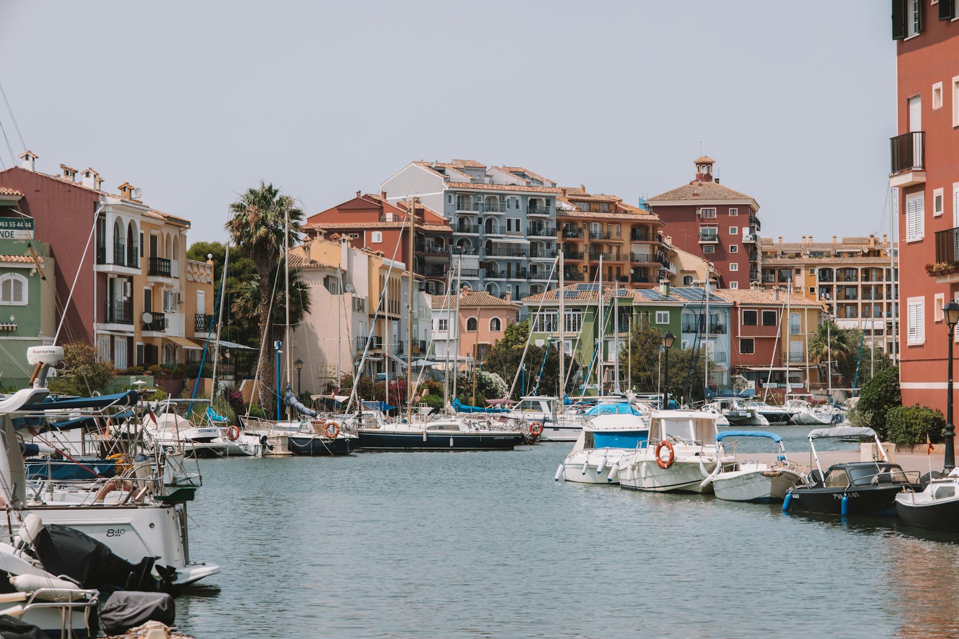 Colorful buildings and boats in the picturesque Port Saplaya, Valencia, Spain, showcasing a delightful urban setting by the sea.