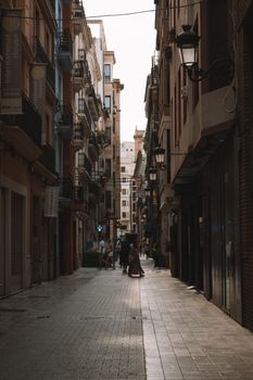 Discover a picturesque narrow alley in Valencia, Spain, showcasing urban life and historic architecture.