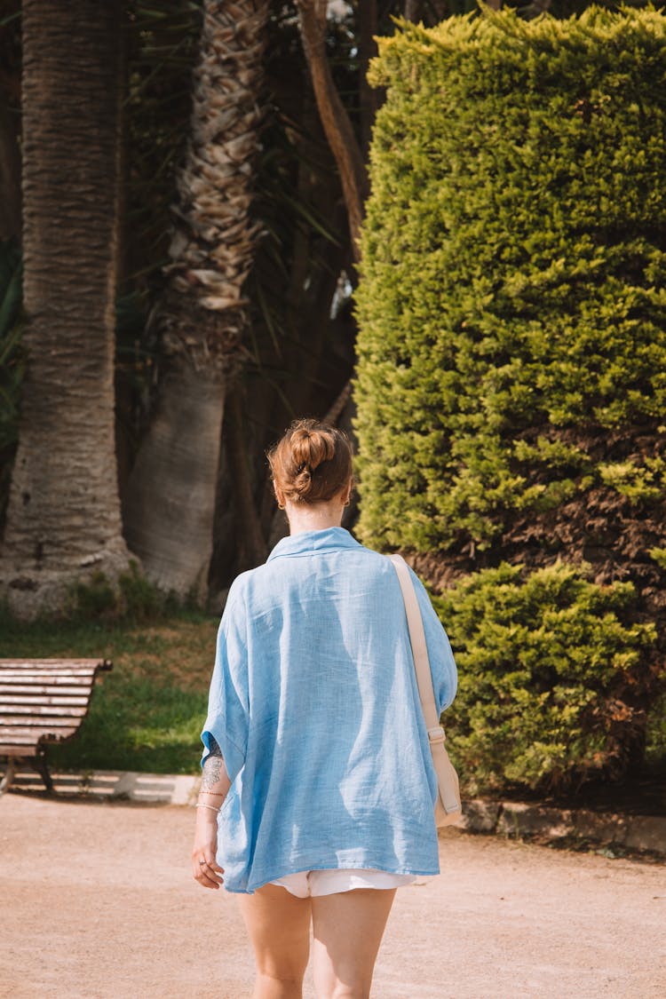 Back View Of A Woman Walking In A Park In Summer