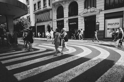 Black and White Picture of People on a Crosswalk in City 