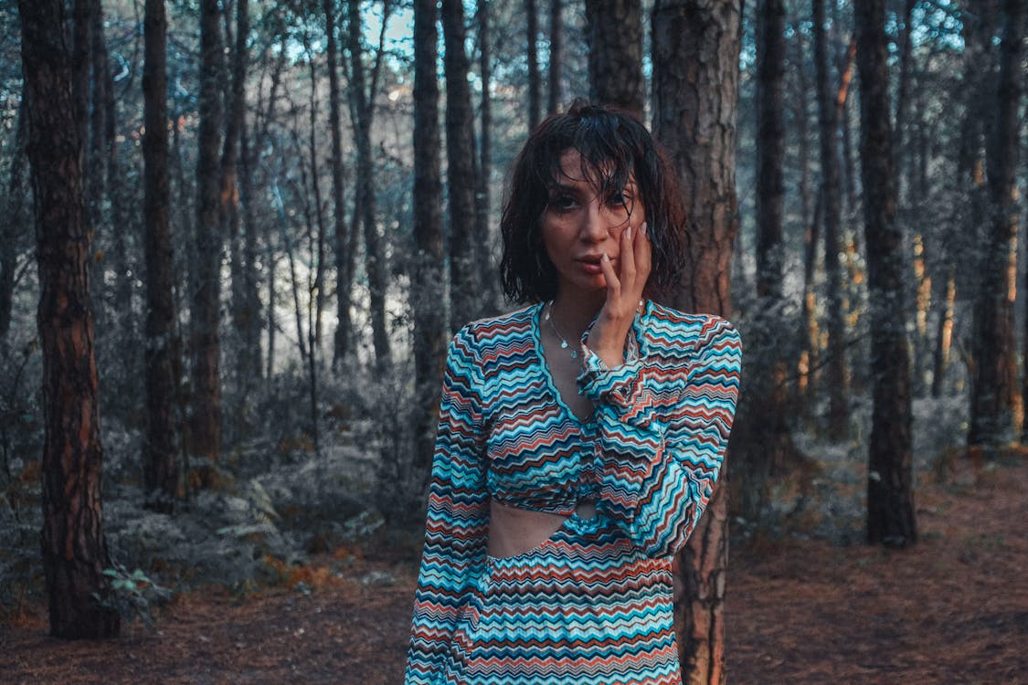 Young Woman with Wet Hair Standing in the Forest 