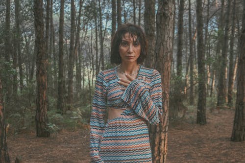 Young Woman with Wet Hair Standing in the Forest 