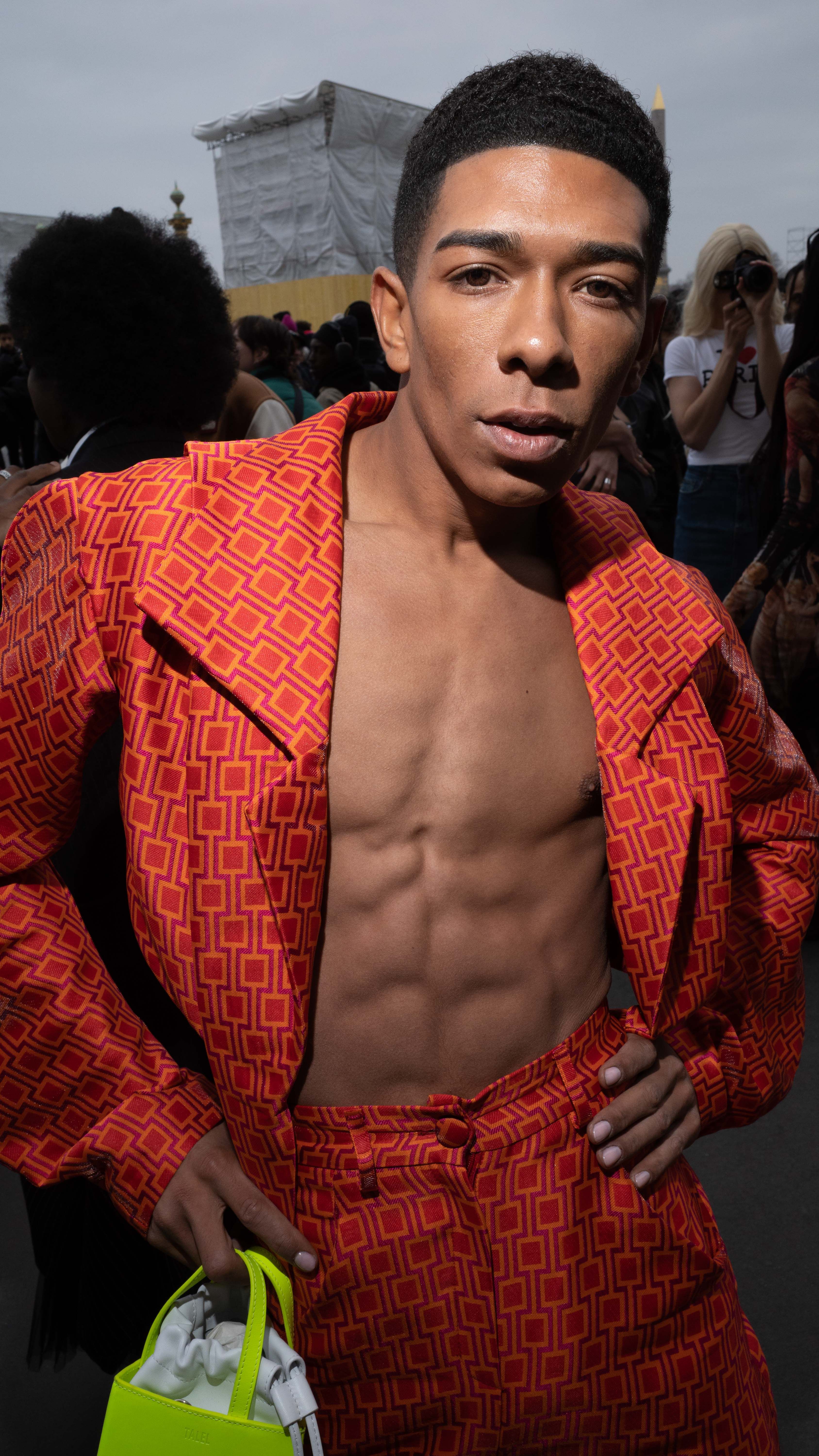 Urban fashion portrait featuring a confident man in bold red patterned attire.