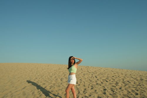 Young Woman Standing on an Empty Beach 