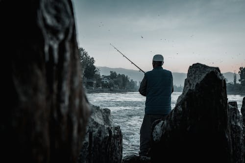 Kostenloses Stock Foto zu angelrute, angler, felsen