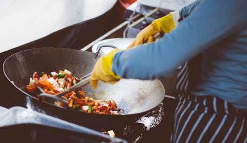 Free Person Cooking on Stainless Steel Cooking Pot Stock Photo