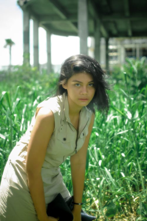 Young Woman Standing on a Field 