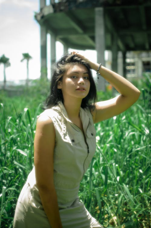 Young Woman Posing on a Grass Field 