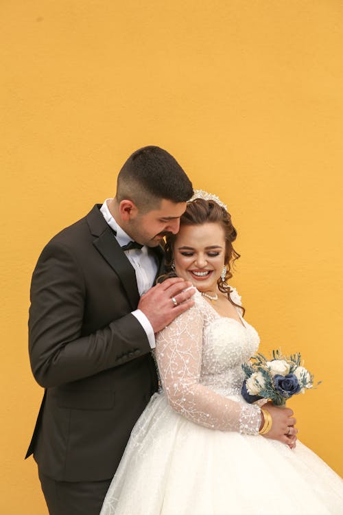 Smiling Newlyweds on Yellow Background