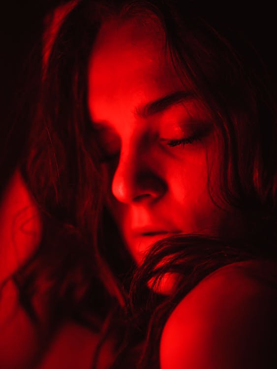 Studio Shot of a Young Woman in Red Lighting 