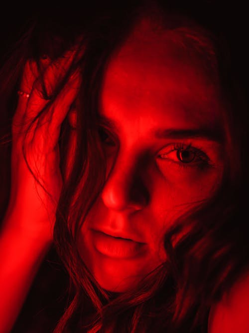 Studio Shot of a Young Woman in Red Lighting 