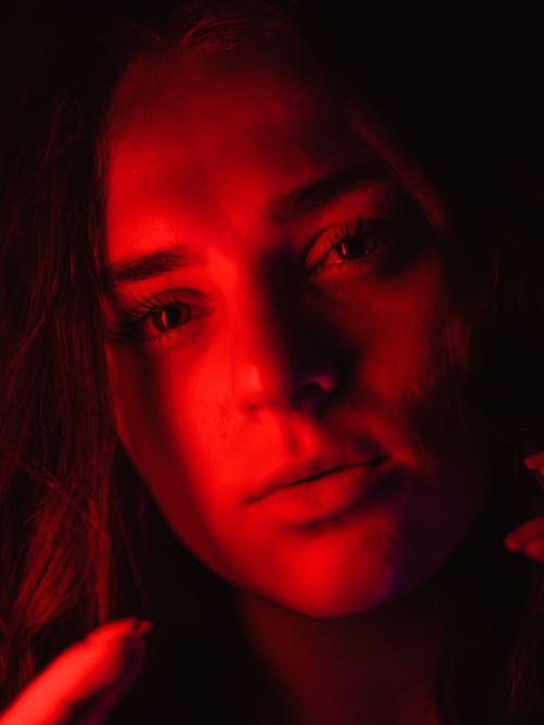 Portrait of Young Woman in Red Light