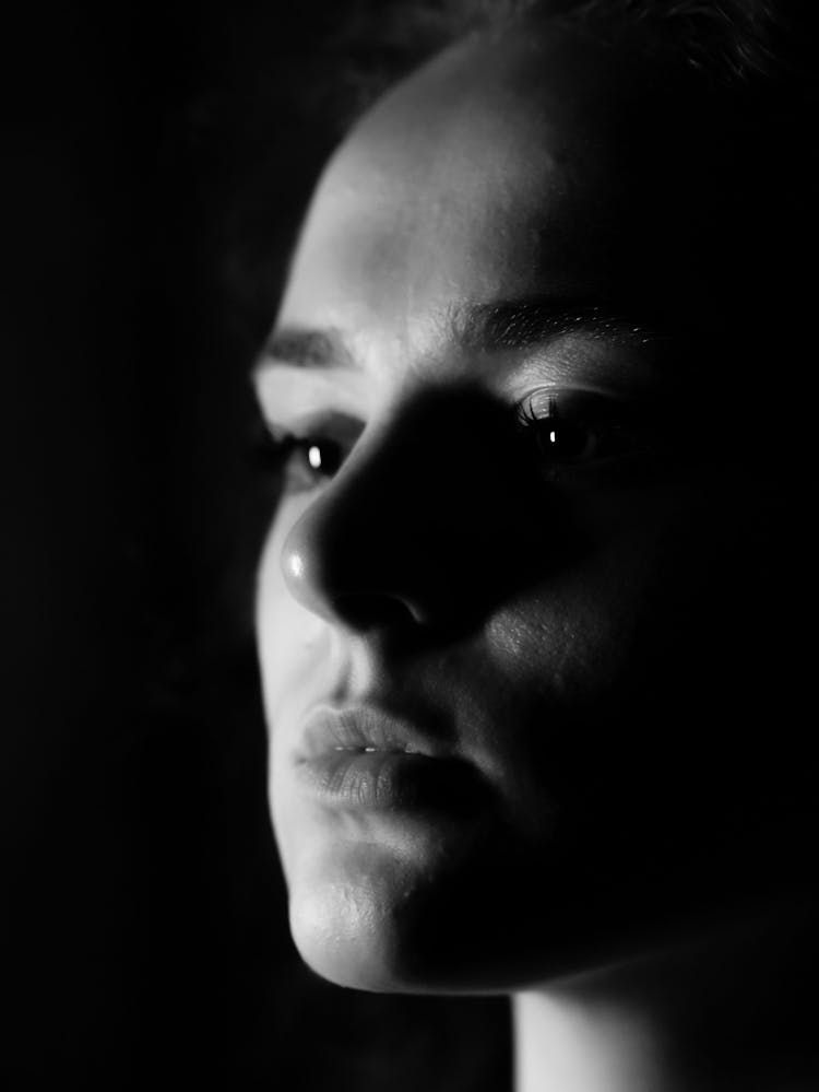 Close-up Of Young Woman Portrait In Dark