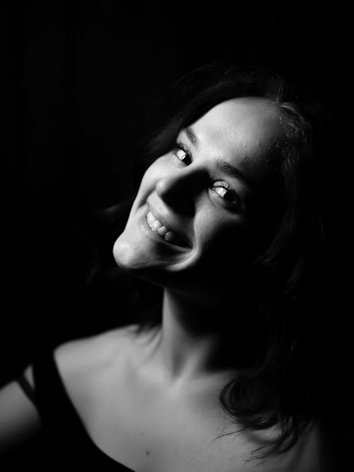 Portrait of Smiling Woman Posing in Dark