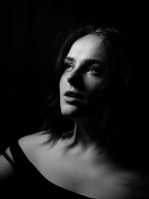 Free Striking black and white portrait of a woman with dramatic lighting and shadows. Stock Photo