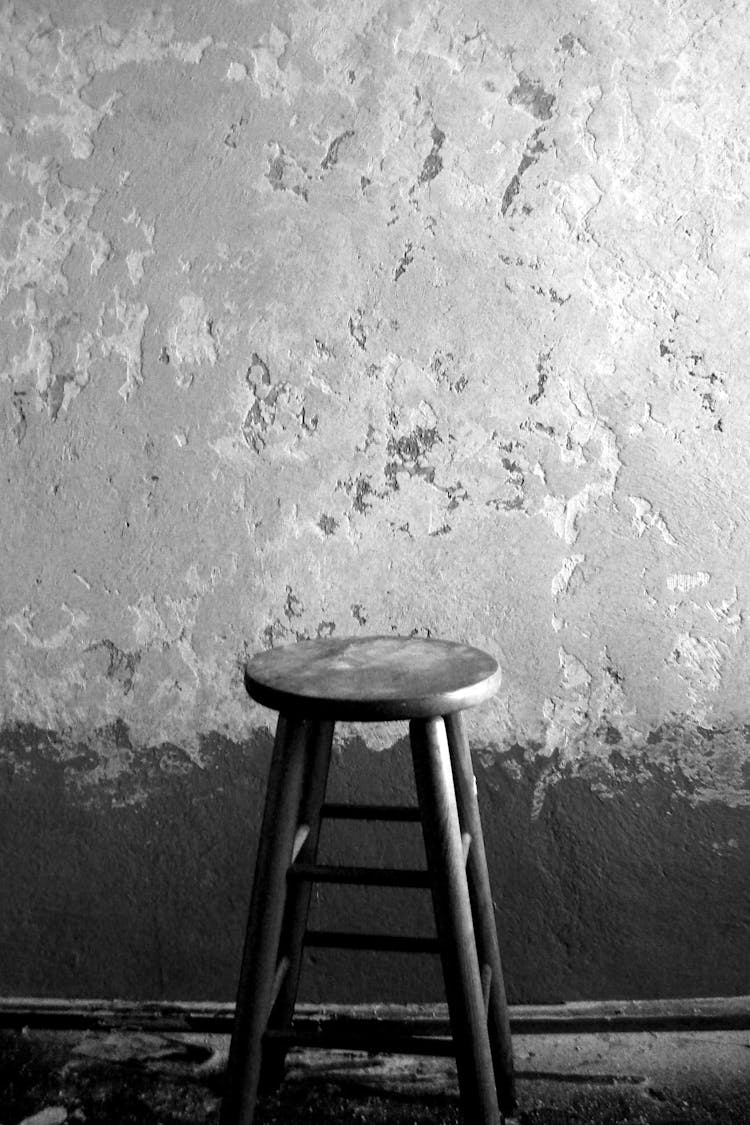 Wooden Stool By Textured Wall