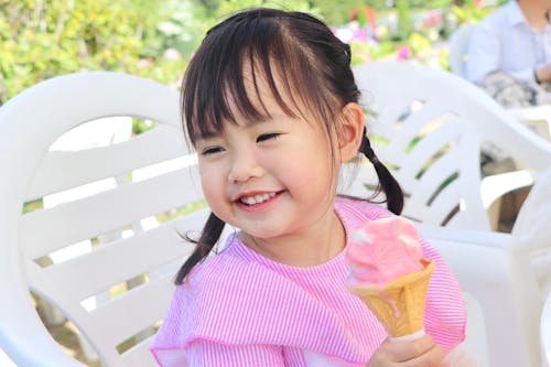 Smiling Girl Eating Ice Cream