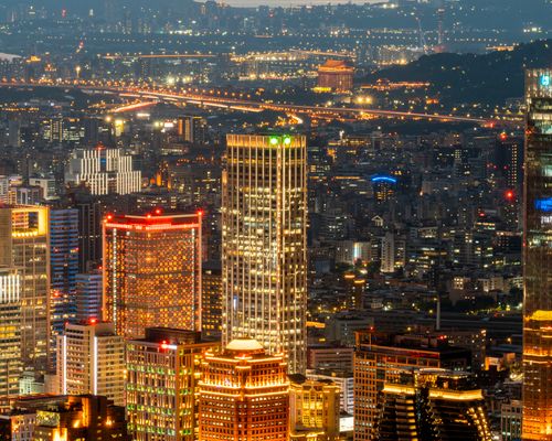 Free Illuminated urban skyline showcasing vibrant city lights and towering skyscrapers. Stock Photo