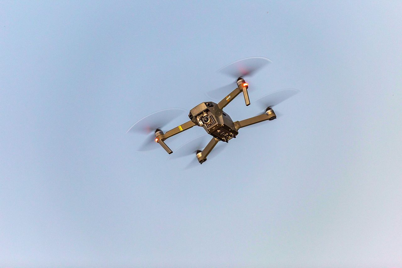 aerial view of a drone in motion against a blue sky illustrating moder