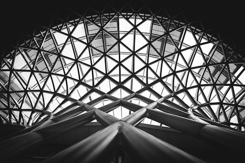 Free Low Angle Photography of Metal Building on Grayscale Stock Photo
