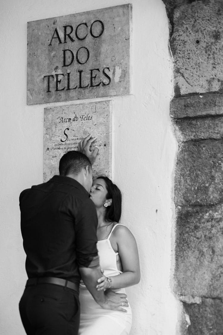 Couple Kissing By Arco Do Teles Board On Wall In Rio De Janeiro