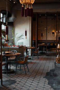 A stylish modern restaurant interior featuring chic furniture and warm lighting.