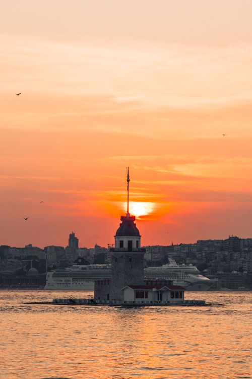 Free Stunning view of Istanbul's Maiden Tower silhouetted against a vibrant sunset backdrop. Stock Photo