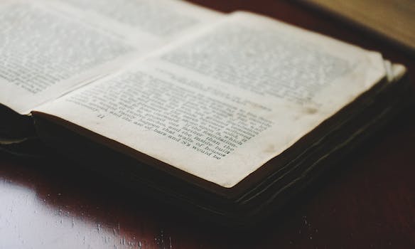 Close-up of an open book displaying textured pages and visible text, ideal for literary themes.
