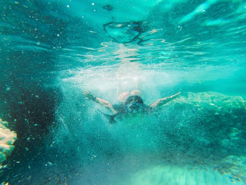 Woman Snorkeling in Clear Sea Water